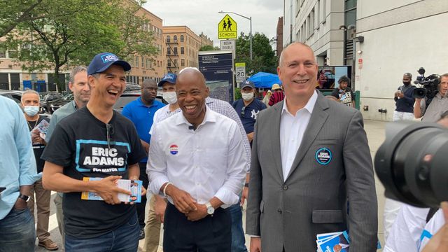 A photo of Eric Adams flanked by supporters Ydanis Rodriguez (left) and Adam Clayton Powell IV (right)